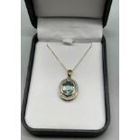 9ct yellow gold ladies necklace with a 9ct yellow gold pendant set with a large blue topaz stone off