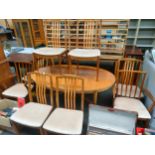 Teak dinning room table with 8 chairs to include two carver's