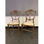 A Pair of Edwardian dinning room chairs with fitted silk upholstery