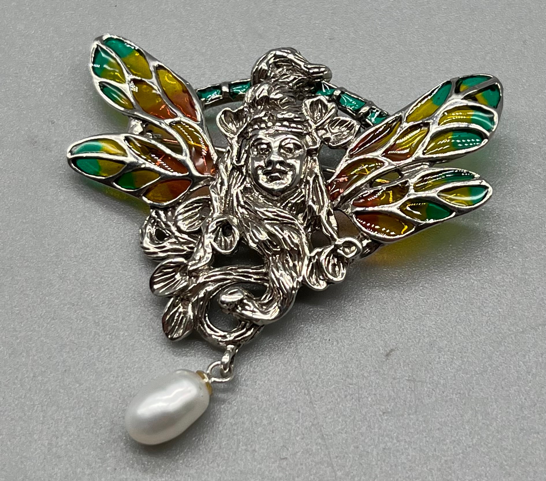 A Silver Art Nouveau style plique a jour fairy pendant/ brooch with pearl drop.