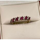 14ct yellow gold ruby and diamond ring, set with alternating navette cut rubies and pairs of round