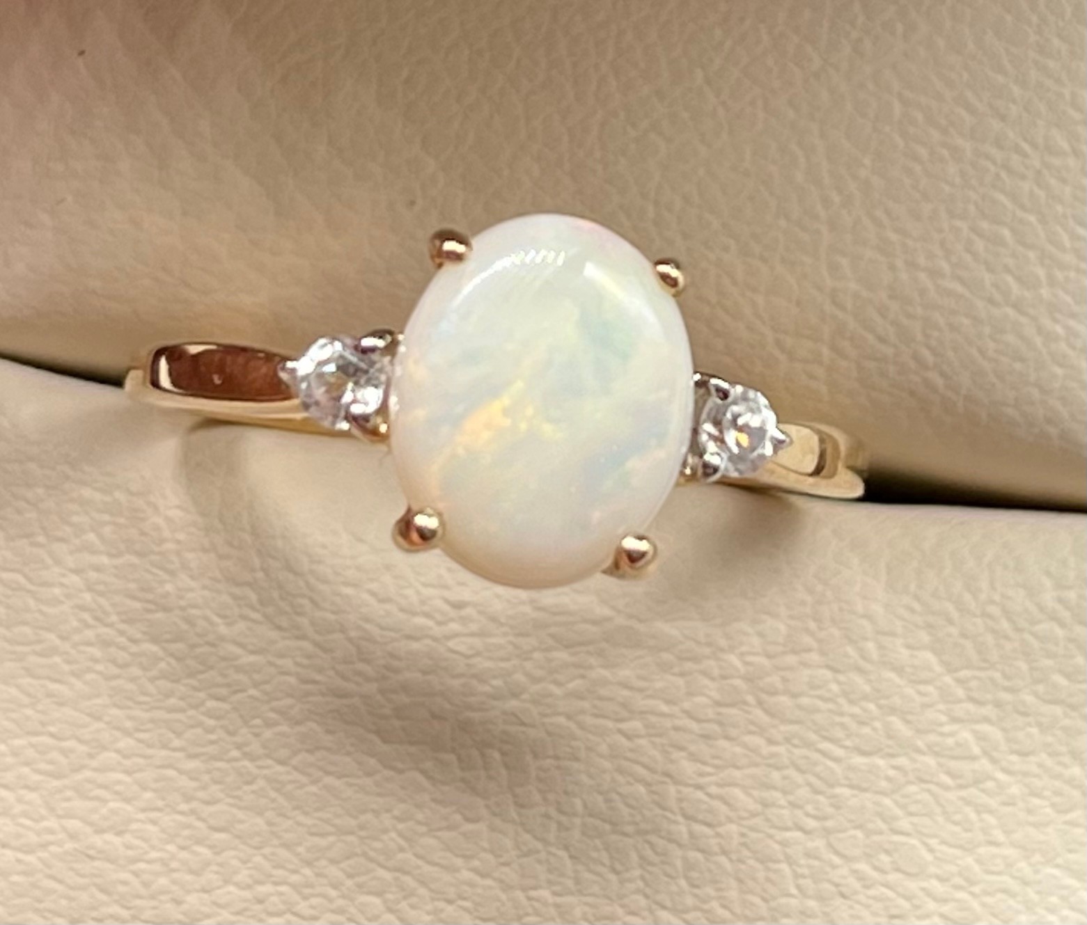 10ct yellow gold ladies ring set with an white opal stone off set by White Spinel stones. [Ring size - Image 2 of 2