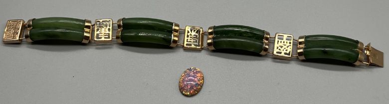 A Chinese gilt metal and green jade bracelet together with a opalescent style stone.