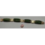 A Chinese gilt metal and green jade bracelet together with a opalescent style stone.