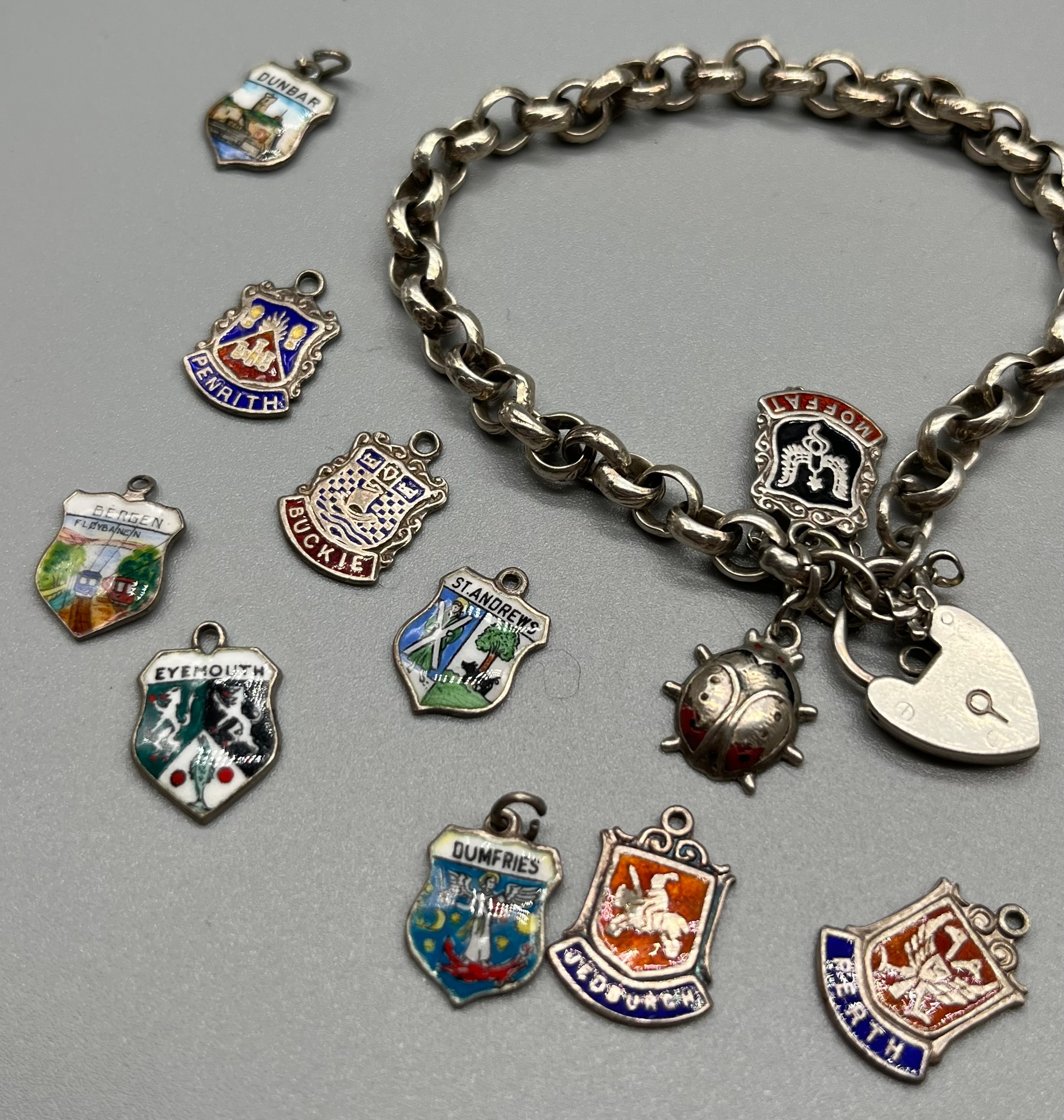 Silver charm bracelet together with silver and enamel souvenir shield fobs. - Image 3 of 3