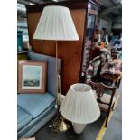 A Large brass floor light along with large interior table lamp