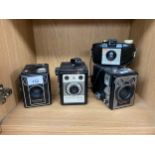 Shelf of vintage cameras to include conway camera, six 20 brownie camera etc