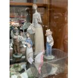 A Collection of Lladro & Nao figurines to include the footballer, Girl holding doll etc