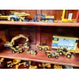 A shelf of cat vehicles digger etc