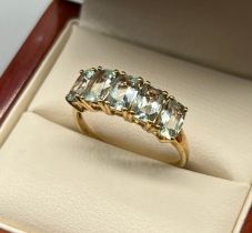 10ct yellow gold ladies ring set with 5 aquamarine stones. [Ring size P] [2.24Grams]