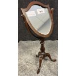 Antique Mahogany small table top shield shaped mirror. Single pedestal with three outswept feet. [