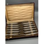 A Set of 12 French Christofle silver plated marked large knives. Comes with original box.