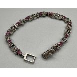 A Silver 925 marcasite and ruby line bracelet.