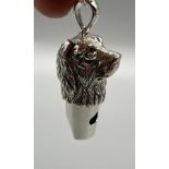 A Sterling silver whistle in the form of a dogs head, Comes with a silver necklace.