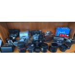 A Large collection of cameras & lenses to include Polaroid, Kodak baby hawkeye, various lenses