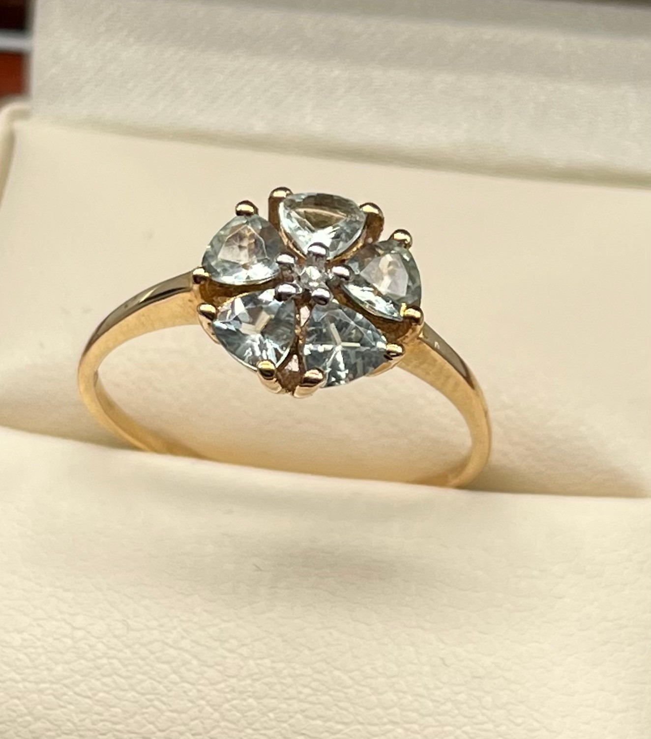 9ct yellow gold ladies ring set in a flower design using a single white spinel stone of set by