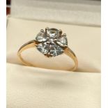 9ct yellow gold ladies ring set in a flower design using a single white spinel stone of set by