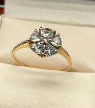 9ct yellow gold ladies ring set in a flower design using a single white spinel stone of set by