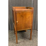Antique side cupboard, the gallery tray top, above a door opening to interior storage, raised on