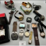 A small box containing a collection of mixed watches to include Casio digital watches, Fossil,