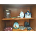 Two shelves of collectables to include Royal Doulton jar, elephant figures and magnifying glass.