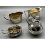 Four small silver jugs/ cream jugs. Lidded jug- Birmingham silver produced by William Clark & Son,