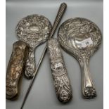 A Mixed lot of silver dressing table items to include two highly decorative hand mirrors and two