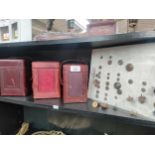 Shelf of 19th century brass carriage clock cases and two sleeves of military antique uniform