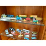 Two shelves of play worn vehicles to include Matchbox, Dinky and Corgi.