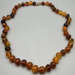 Vintage Raw amber bead necklace fitted with an 18ct yellow gold clasp and catch. [72.21grams]