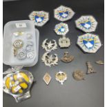 Two boxes of military cap badges, AA car badge and police patches.