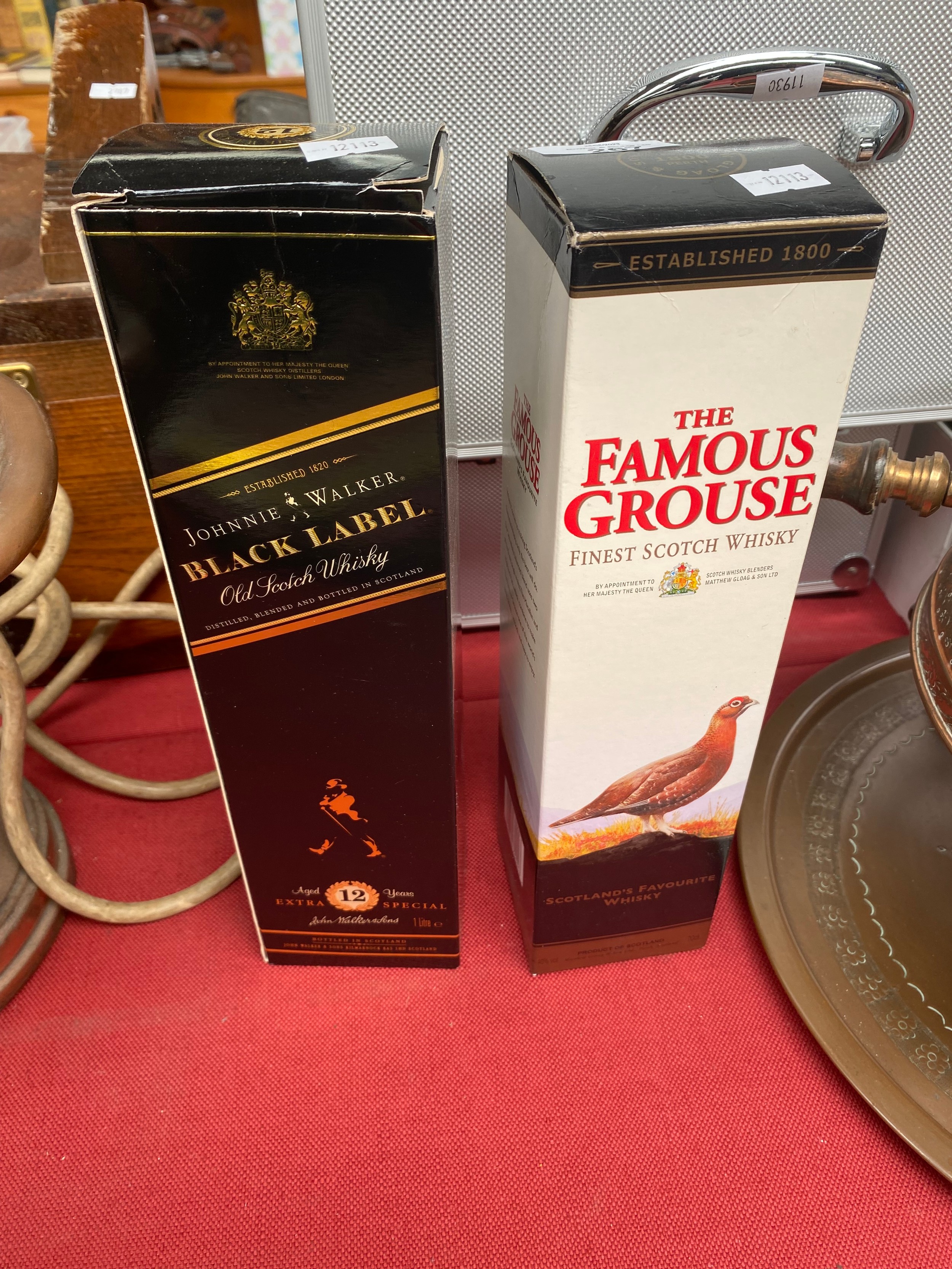 A bottle of Black label johnny walker old scotch whisky along with The Famous grouse scotch whisky