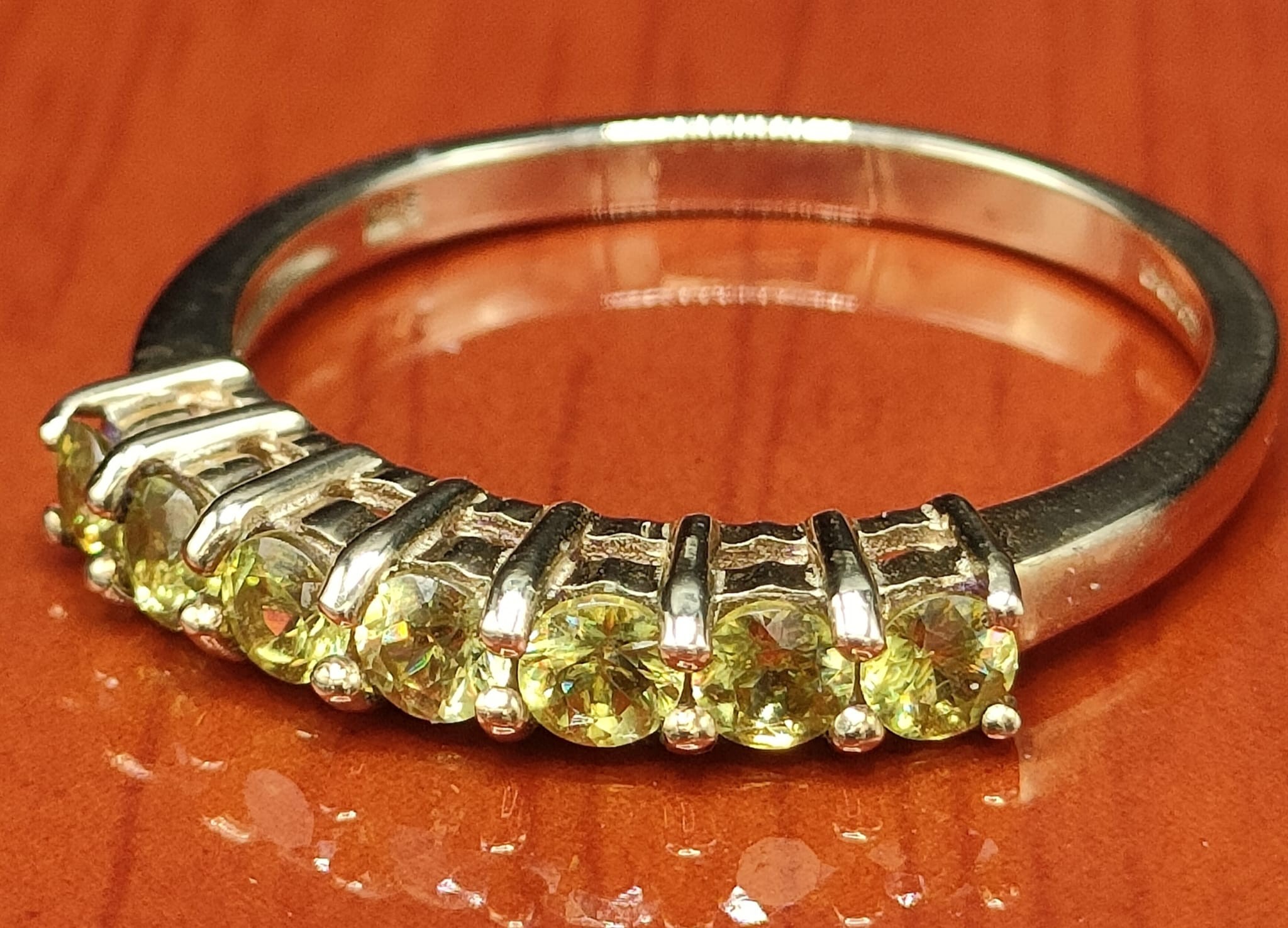 9ct yellow gold ring set with seven green stones. [Ring size Q 1/2] [2.35Grams] - Image 2 of 2