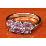 10ct yellow gold ring set with 6 purple topaz stones set with white spinel stones. [Ring size P] [