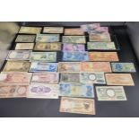 A large selection of world bank notes from America, Denmark, Bahrain, Saudi Arabia, Iran, France and