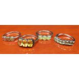 Four 925 silver and gem stone rings includes three opalescent orange stone set ring.