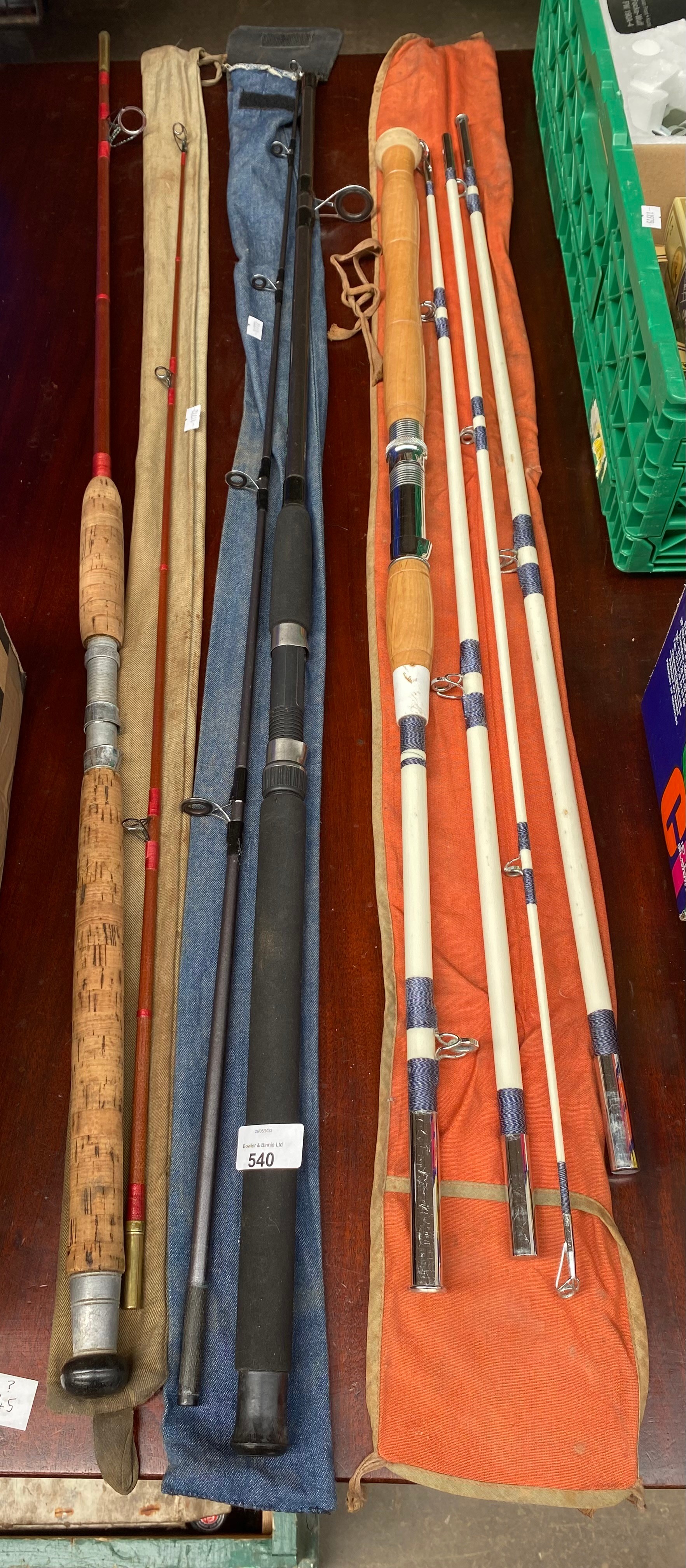 A Selection of fishing rods with bags