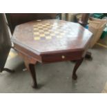 Octagonal brass inlaid chess table.