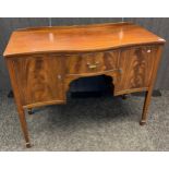 20th century mahogany serpentine front sideboard, central drawer, flanked by two doors leading to