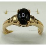 9ct yellow gold ring set with a cabochon cut black star diopside stone. [Ring size N] [2.74Grams]