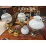 A collection of 3 brass oil lamps along with vintage brass tea light