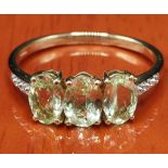 10ct yellow gold ladies ring set with three pale green stones. [Ring size P] [2.09Grams]