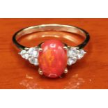 10ct yellow gold ladies ring set with a large fire opal off set by white spinel stone shoulders. [