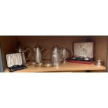 A Shelf of Silver plated wares includes Silver plated cruet set in fitted box, Plated Tea pots &