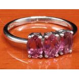 10ct white gold ring set with three purple gem stones. [Ring size M 1/2] [1.92Grams]