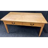 19th century pine table, the rectangular top above two drawers, raised on square tapered legs [