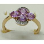 10ct yellow gold ring set with four purple topaz stones surrounded by white spinel stones. [Ring