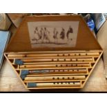 A cased set of wooden carved flutes