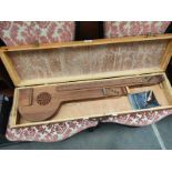 An Eastern themed 6 String musical banjo style instrument in fitted case