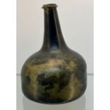 17th century Green glass onion bottle with an Iridescence throughout. [16.5cm high]